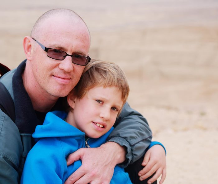 a man with his arm around a boy